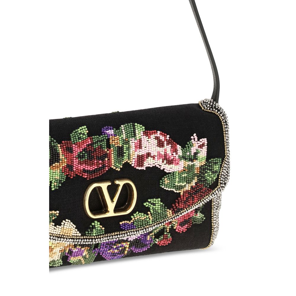 Small Shoulder Bag by Valentino Garavani for women in calfskin leather & linen gold, multicolor, floral & signature features a enviable silhouette, showcasing a secure magnetic, ample single-compartment, and enviable shoulder-strap, adjustable-strap & handle for a enviable finish.