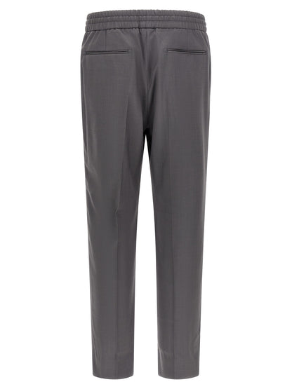 Trousers by Brioni for men in wool gray presents a perennial silhouette, meticulously tailored with a straight-leg cut, long finish, and an elegant .