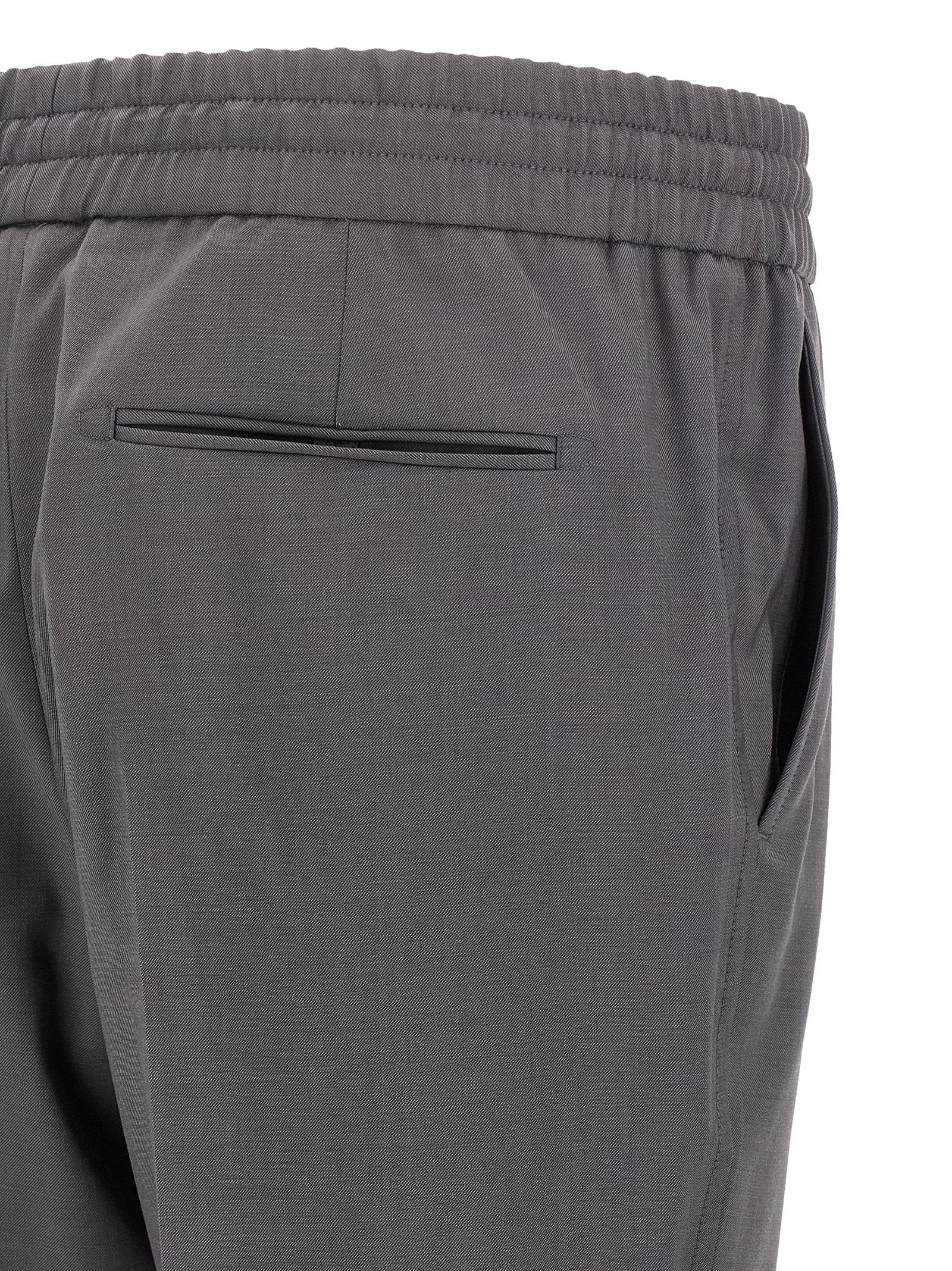 Trousers by Brioni for men in wool gray features a artisanal silhouette, showcasing a sophisticated straight-leg with a long and for a artisanal finish.
