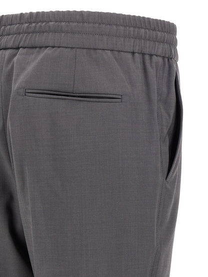 Trousers by Brioni for men in wool gray features a artisanal silhouette, showcasing a sophisticated straight-leg with a long and for a artisanal finish.