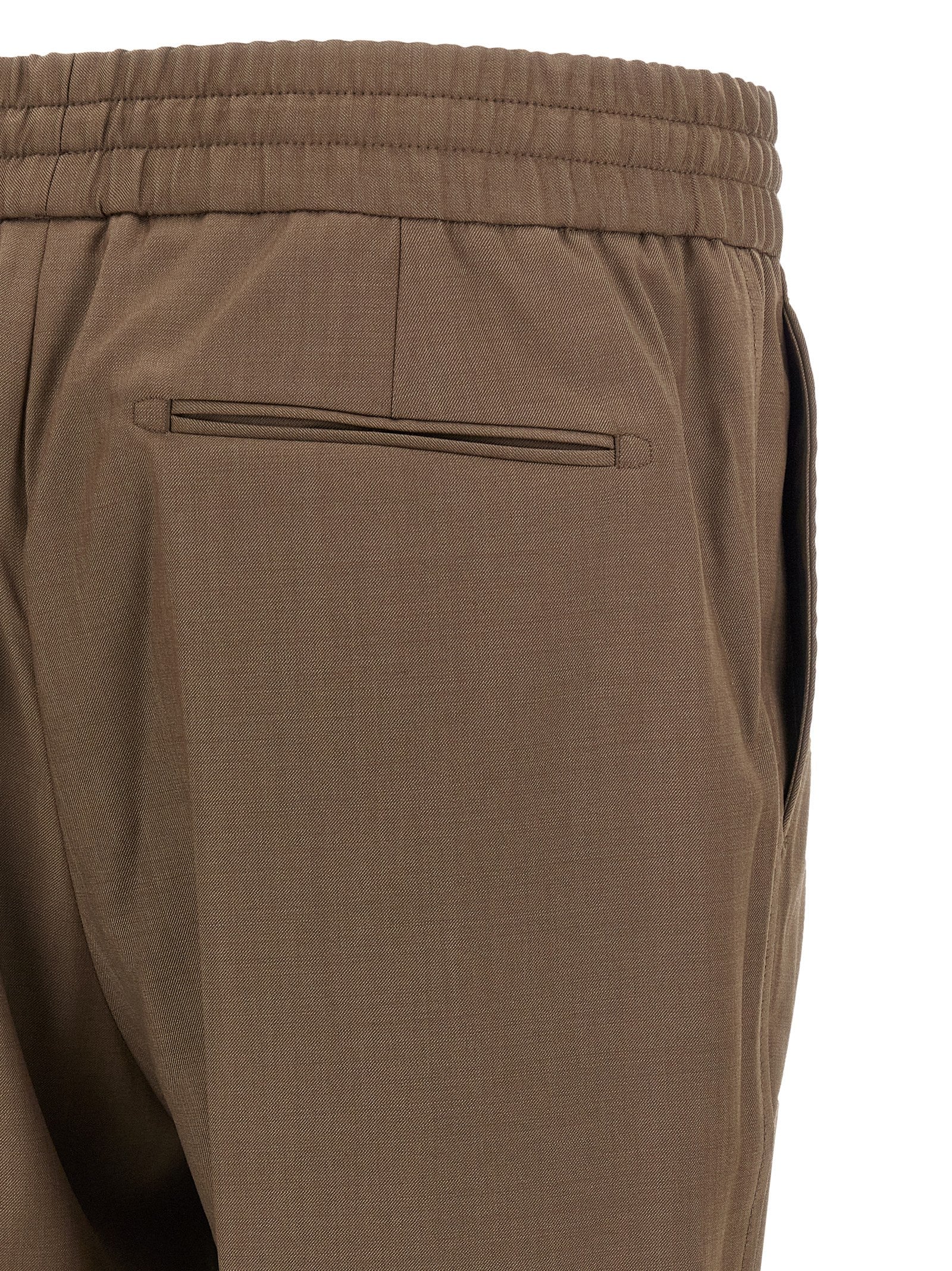 Trousers by Brioni for men in wool brown features a tailored silhouette with a tailored straight, defined by its long and a sophisticated .