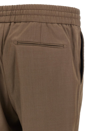 Trousers by Brioni for men in wool brown features a tailored silhouette with a tailored straight, defined by its long and a sophisticated .