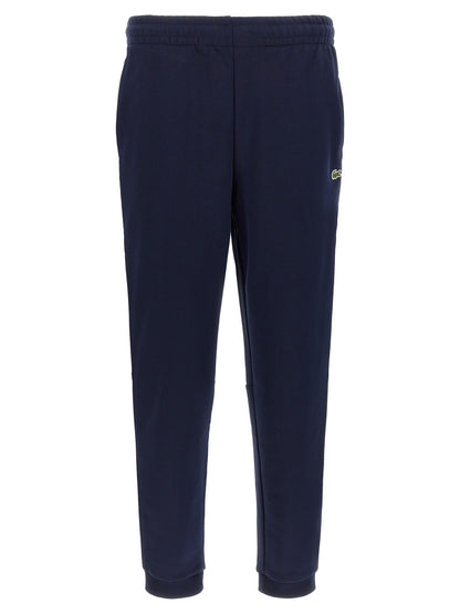 Joggers by Lacoste for men in crocodile skin leather & cotton navy features a refined silhouette with a refined , defined by a and a refined long for a refined finish.