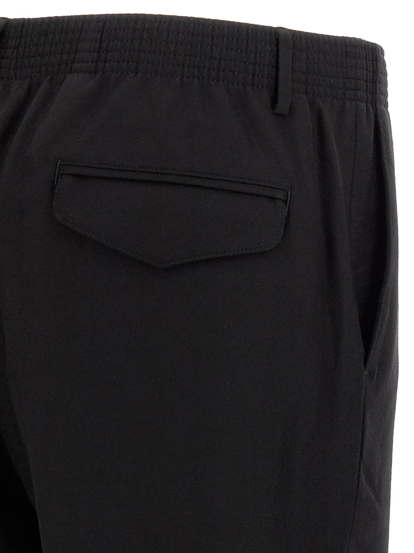 Trousers by CELLAR DOOR for men in virgin wool black features a sculptural silhouette, showcasing a sculptural tapered-leg and long with a sophisticated for a sculptural finish.