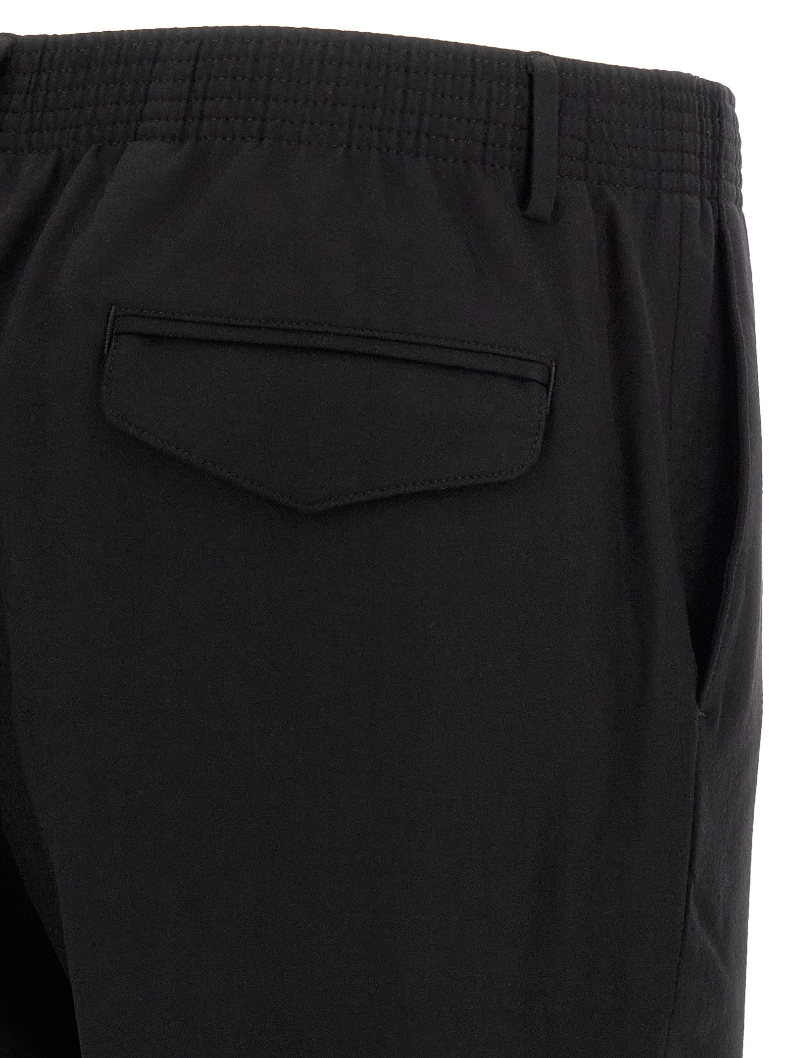 Trousers by CELLAR DOOR for men in virgin wool black features a sculptural silhouette, showcasing a sculptural tapered-leg and long with a sophisticated for a sculptural finish.