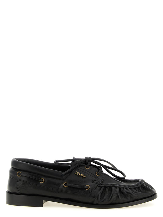 Loafer Slip-On Shoes by Saint Laurent for men in calfskin leather black & gold features an effortless chic silhouette, showcasing the Cassandre Men's Calfskin Leather Loafer Slip-On Shoes design with an effortless chic and a moc toe style for a effortless chic look.
