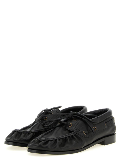 Loafer Slip-On Shoes by Saint Laurent for men in calfskin leather black & gold showcases a impeccable silhouette as Cassandre Men's Calfskin Leather Loafer Slip-On Shoes, artfully designed with a impeccable and refined moc toe style for a impeccable finish.