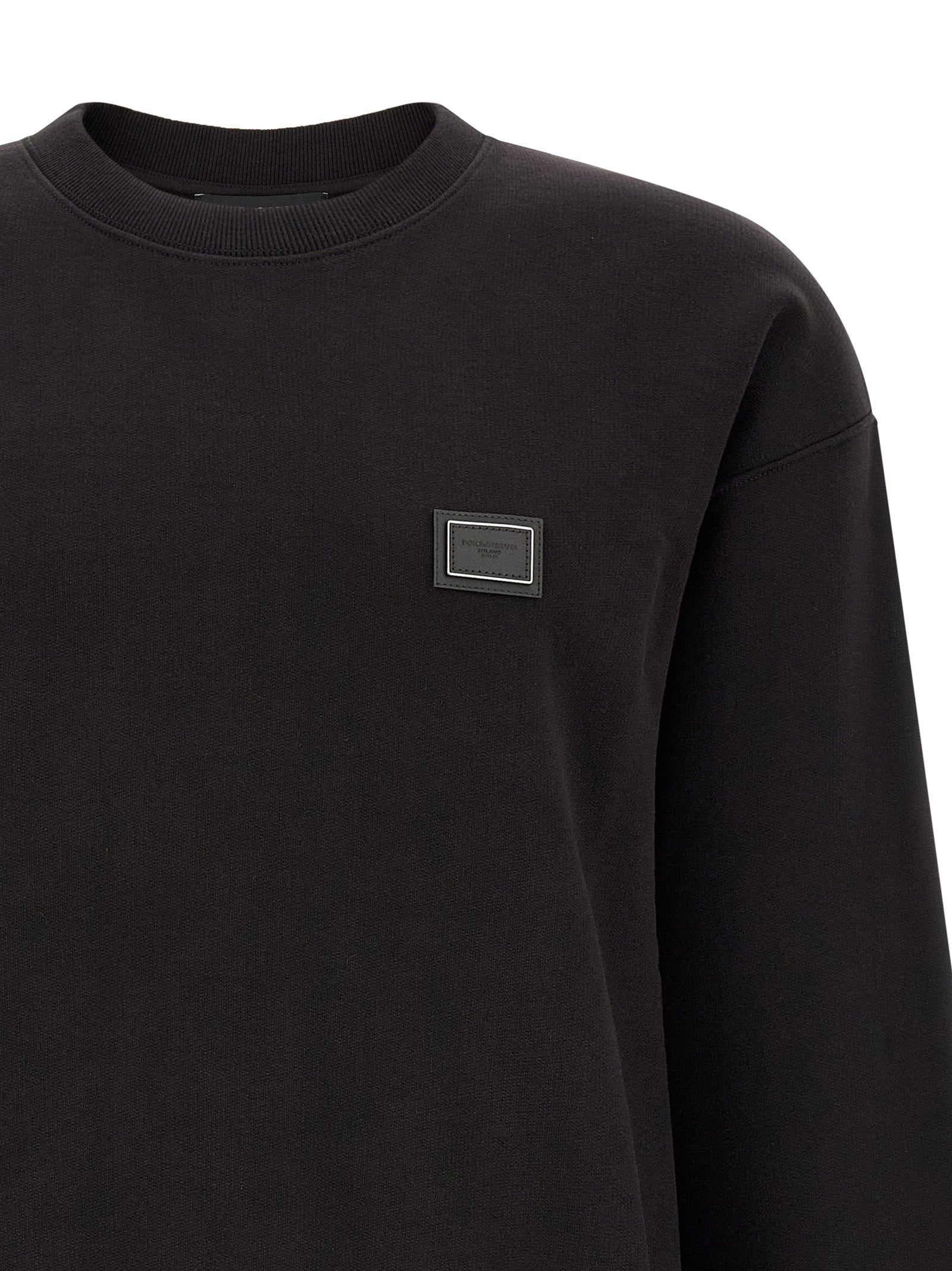 Sweatshirt by Dolce & Gabbana for men in cotton black features an provocated silhouette, detailed with a provocated and a refined crew neckline for a sophisticated aesthetic.