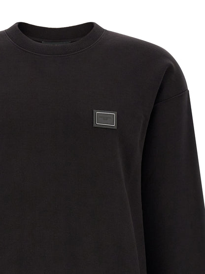 Sweatshirt by Dolce & Gabbana for men in cotton black features an provocated silhouette, detailed with a provocated and a refined crew neckline for a sophisticated aesthetic.