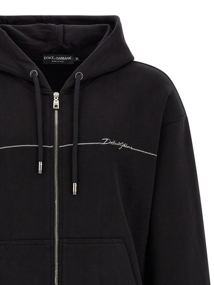 Sweatshirt Hoodie by Dolce & Gabbana for men in cotton satin black & silver features a slouchy chic silhouette, detailed with a slouchy chic and a signature hooded neckline for an elevated aesthetic.