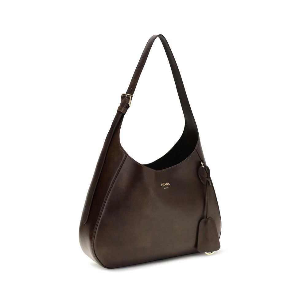 Medium Shoulder Bag by Prada for women in bos taurus calf leather brown features a enviable silhouette, showcasing a secure zipper & magnetic, ample , and enviable shoulder-strap, adjustable-strap & handle for a enviable finish.
