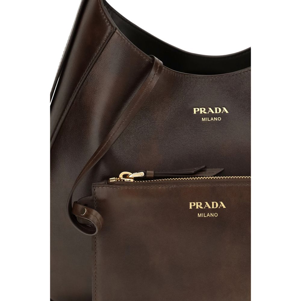 Medium Shoulder Bag by Prada for women in bos taurus calf leather brown features a distinguished silhouette, showcasing a secure zipper & magnetic and distinguished with versatile shoulder-strap, adjustable-strap & handle for a distinguished finish.