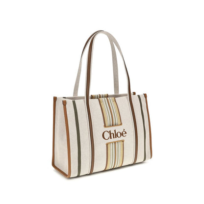 Shoulder Tote Bag by Chloé for women in cotton canvas & calf leather beige & striped features a effortless chic silhouette with a secure magnetic, ample , and versatile shoulder-strap & belt-strap for a effortless chic finish.