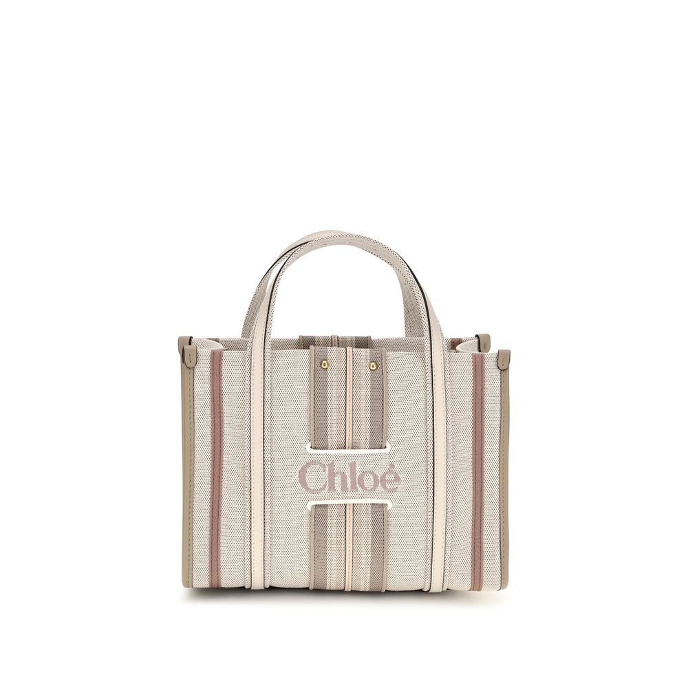 Small 2-in-1 Shoulder & Crossbody Tote Bag by Chloé for women in cotton canvas & calf leather beige & striped features an effortlessly chic silhouette with a secure magnetic, ample , and versatile crossbody-strap, shoulder-strap, handle, adjustable-strap & belt-strap for effortlessly chic everyday luxury.