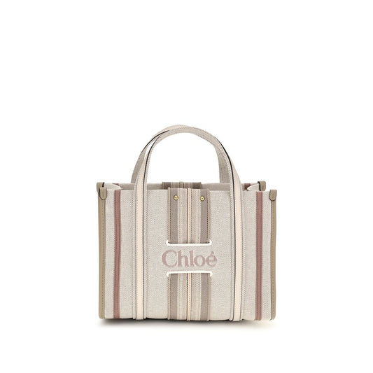 Small 2-in-1 Shoulder & Crossbody Tote Bag by Chloé for women in cotton canvas & calf leather beige & striped features an effortlessly chic silhouette with a secure magnetic, ample , and versatile crossbody-strap, shoulder-strap, handle, adjustable-strap & belt-strap for effortlessly chic everyday luxury.