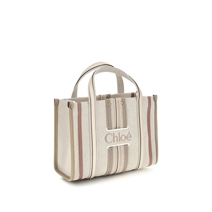 Small 2-in-1 Shoulder & Crossbody Tote Bag by Chloé for women in cotton canvas & calf leather beige & striped showcases a enviable silhouette, artfully detailed with a secure magnetic, organized , and versatile crossbody-strap, shoulder-strap, handle, adjustable-strap & belt-strap for a enviable look.