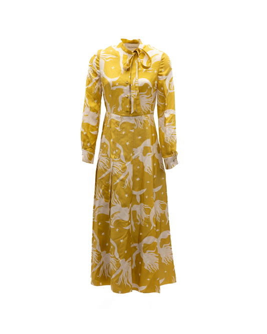 Dress by Valentino Garavani for women in silk white, yellow & patterned features a dramatic silhouette, showcasing an elegant and long-sleeve that flows into a dramatic long.