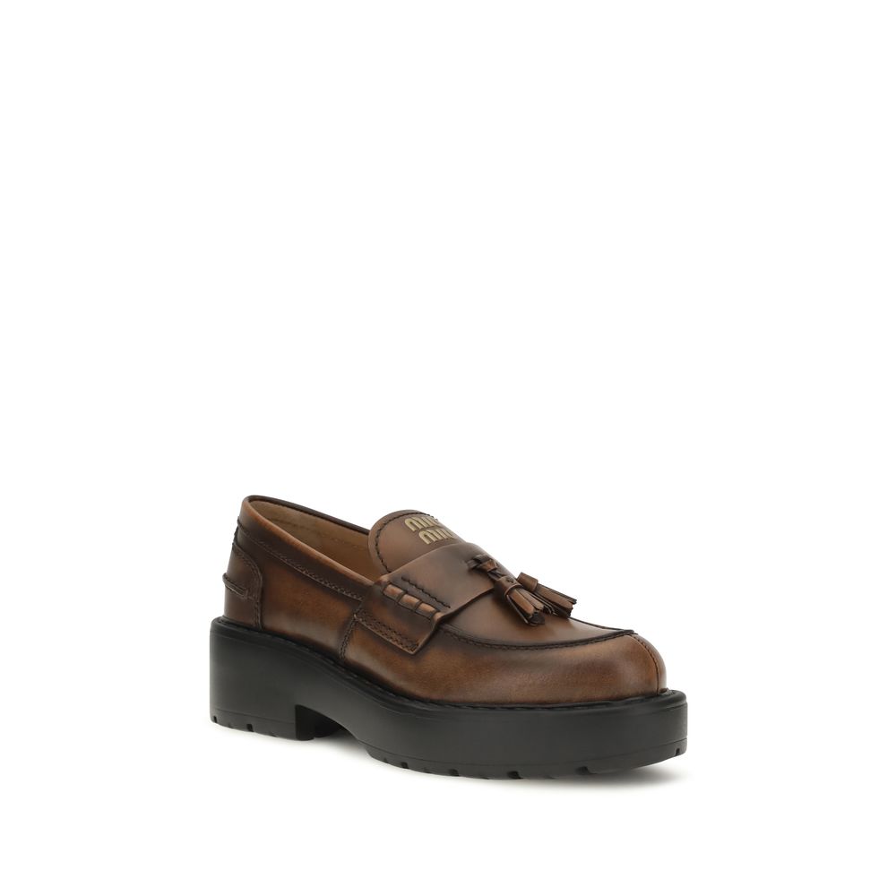 Platform Loafer Shoes by Miu Miu for women in bos taurus calf leather brown features an dynamic silhouette from the Women's Bos Taurus Calf Leather Platform Loafer Shoes collection, defined by a dynamic and platform for a dynamic look.