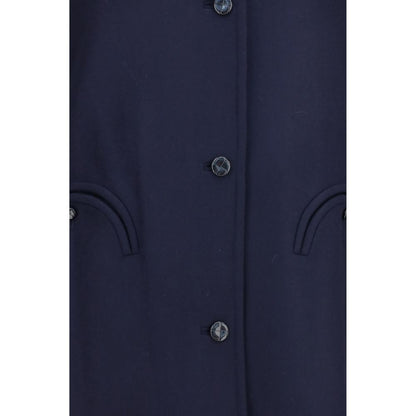 Trench Coat by Blazé Milano for women in merino wool blue presents an sculptural silhouette, artfully detailed with a sculptural and functional pockets & insulated for a truly sculptural finish.