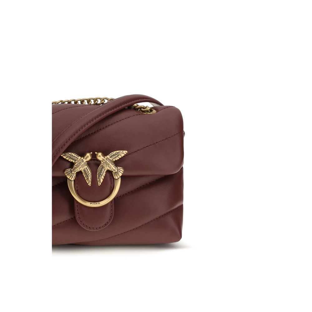 2-in-1 Shoulder & Crossbody Quilted Bag by PINKO for women in bos taurus calf leather bordeaux, gold, signature & monogram features an effortlessly chic silhouette with a secure snap & magnetic, ample , and versatile crossbody-strap & shoulder-strap for effortlessly chic everyday luxury.