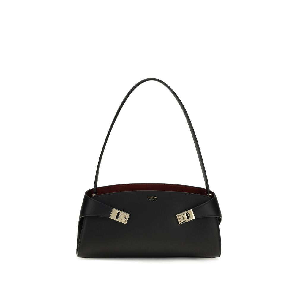 East West Shoulder Bag by Ferragamo for women in bos taurus calf leather black, gold & signature features a effortless sophistication silhouette, secured by a zipper & buckle with ample and versatile shoulder-strap for a effortless sophistication finish.