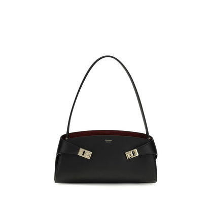 East West Shoulder Bag by Ferragamo for women in bos taurus calf leather black, gold & signature features a effortless sophistication silhouette, secured by a zipper & buckle with ample and versatile shoulder-strap for a effortless sophistication finish.