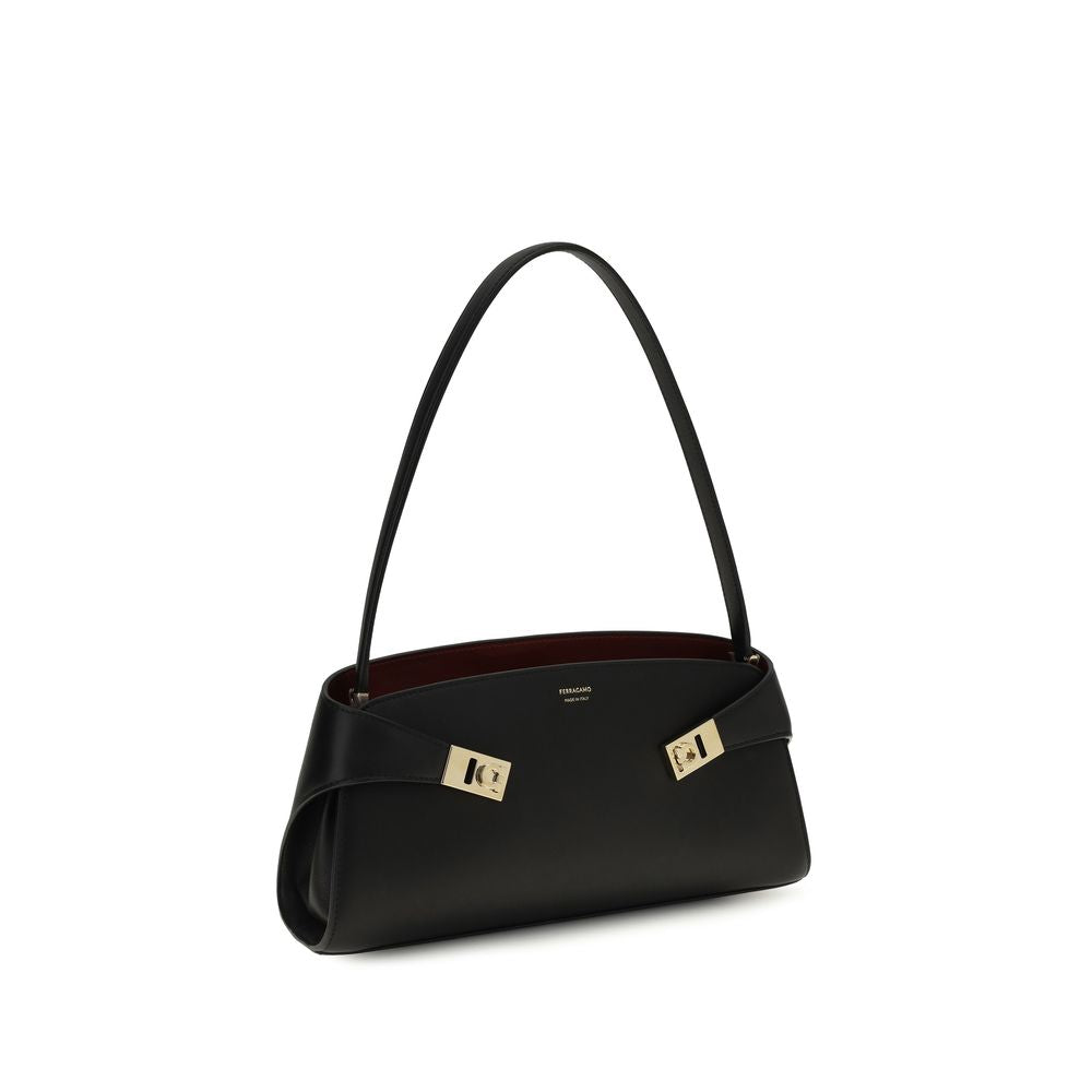 East West Shoulder Bag by Ferragamo for women in bos taurus calf leather black, gold & signature features a enviable silhouette, showcasing a secure zipper & buckle, ample , and enviable shoulder-strap for a enviable finish.