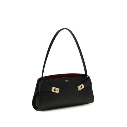 East West Shoulder Bag by Ferragamo for women in bos taurus calf leather black, gold & signature features a enviable silhouette, showcasing a secure zipper & buckle, ample , and enviable shoulder-strap for a enviable finish.