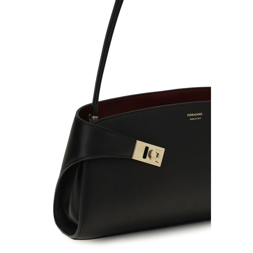 East West Shoulder Bag by Ferragamo for women in bos taurus calf leather black, gold & signature features a effortless chic silhouette with a secure zipper & buckle, ample , and versatile shoulder-strap for a effortless chic finish.