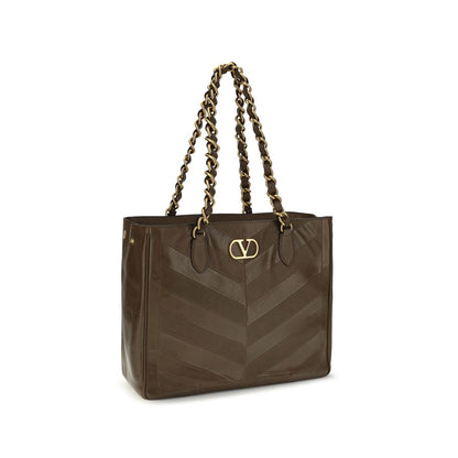 Shoulder Shopper Bag by Valentino Garavani for women in bos taurus nappa calf leather brown, gold, patterned, chevron, signature & patchwork showcases a enviable silhouette, artfully detailed with a secure magnetic, organized , and versatile shoulder-strap & handle for a enviable look.