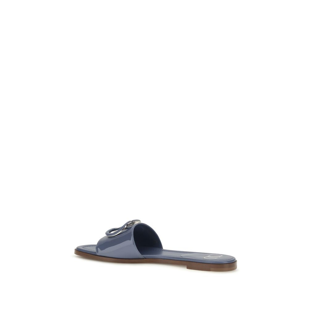 Flat Slider Sandals by Valentino Garavani for women in bos taurus calf patent leather and blue presents a captivating silhouette, showcasing the signature style of the V Logo Women's Bos Taurus Calf Patent Leather Flat Slider Sandals with a captivating flat and captivating open toe style.