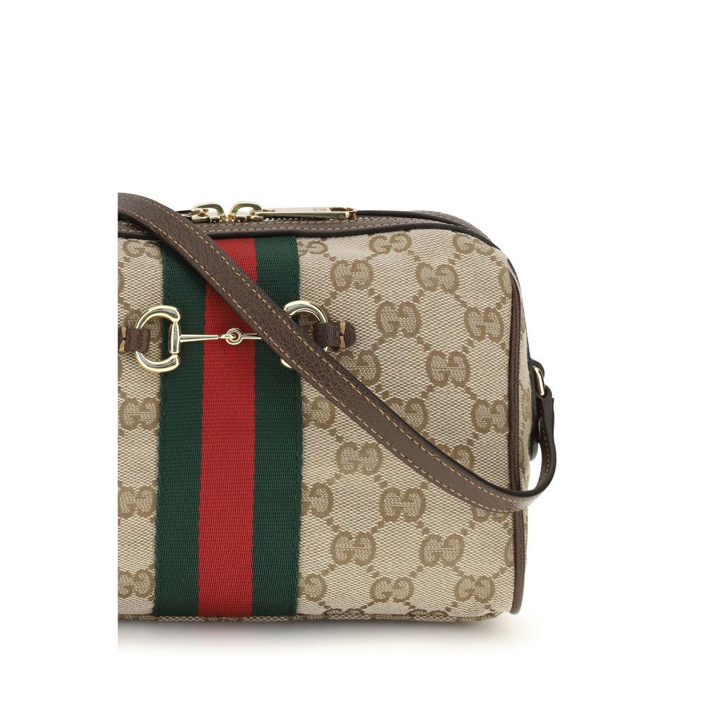 Compact Shoulder Camera Bag by Gucci for women in leather & canvas beige, brown, gold, patterned, signature & striped features an effortlessly chic silhouette with a secure zipper, ample , and versatile shoulder-strap & adjustable-strap for effortlessly chic everyday luxury.