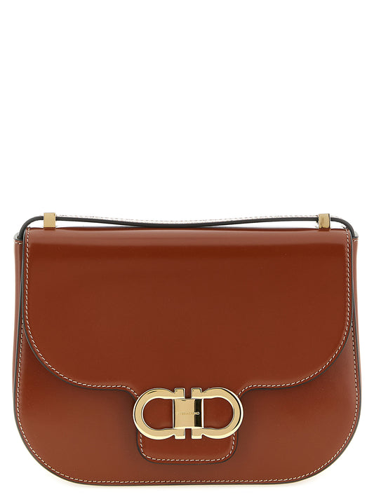 Crossbody Handbag by Ferragamo for women in calfskin leather brown, gold & signature features an multi-faceted design with a secure , ample , and versatile crossbody-strap & adjustable-strap for a multi-faceted finish.