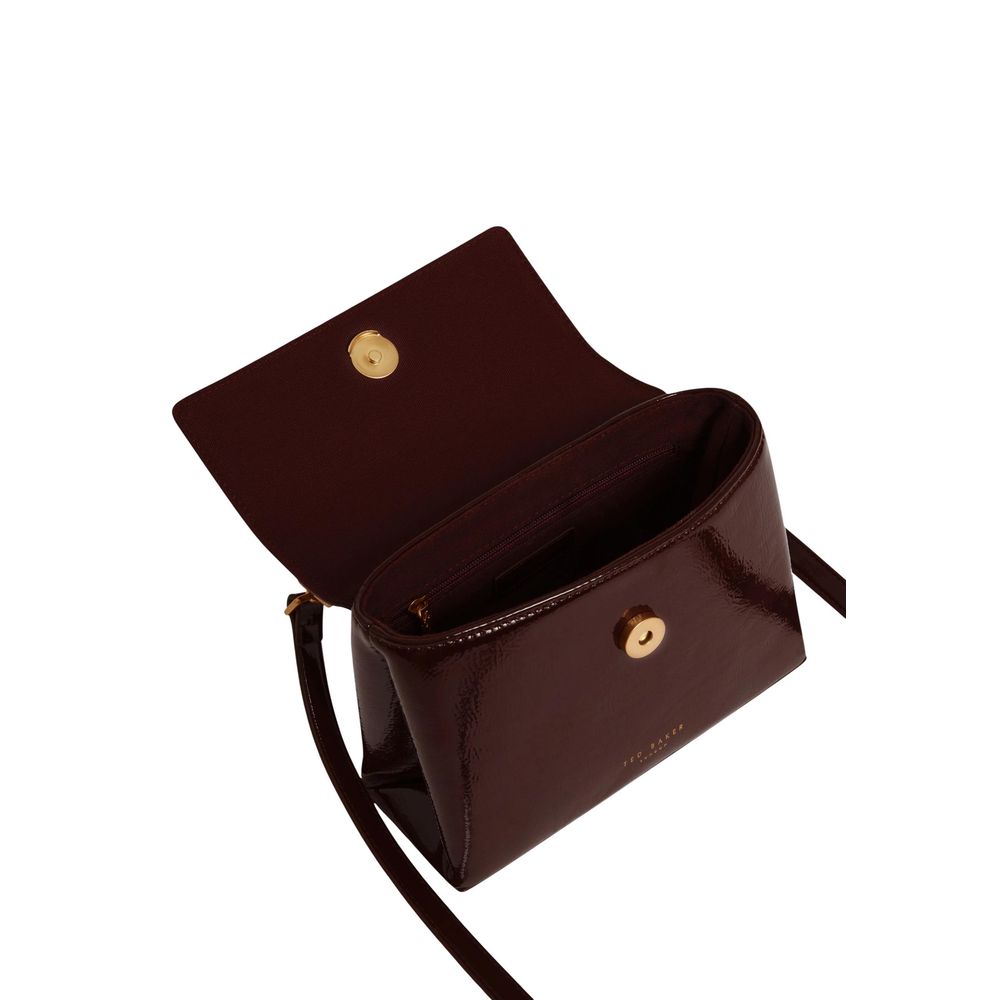 This Mini Shoulder Tote Handbag by Ted Baker for women in polyurethane and gold, purple, rose & signature presents a sculptural silhouette featuring a secure magnetic & clasp, ample , and versatile shoulder-strap, handle & adjustable-strap for a sculptural finish.