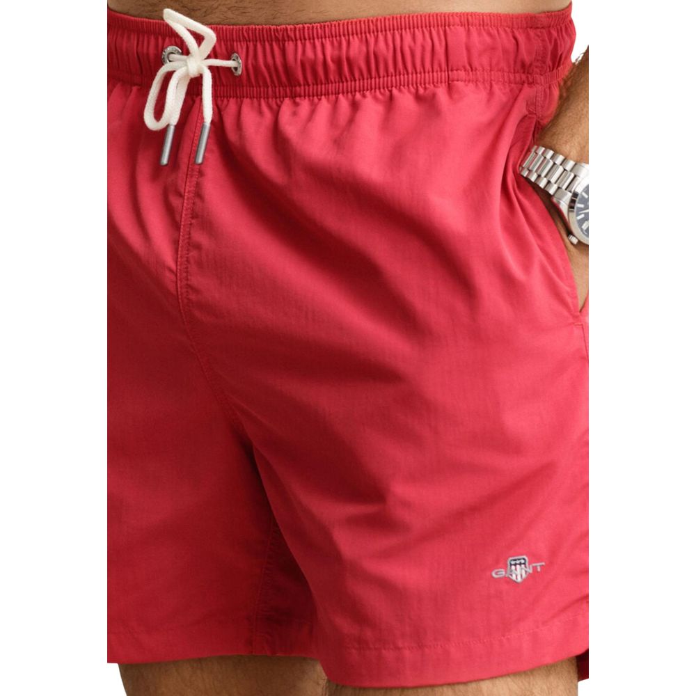 Swim Shorts from Gant for men in polyamide & mesh red features an sleek silhouette, showcasing the distinct style of the Men's Polyamide & Mesh Swim Shorts collection.
