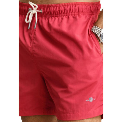 Swim Shorts from Gant for men in polyamide & mesh red features an sleek silhouette, showcasing the distinct style of the Men's Polyamide & Mesh Swim Shorts collection.
