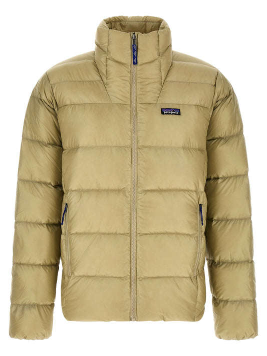 Puffer Jacket by PATAGONIA for men in nylon fabric beige features a dramatic silhouette, showcasing a sophisticated high-neck neckline and distinctive thermal, pockets & insulated for a dramatic aesthetic.