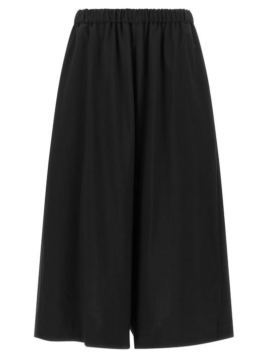Trousers by Comme Des Garçons for women in wool black features a artisanal silhouette, showcasing a sophisticated wide & cropped with a cropped and for a artisanal finish.