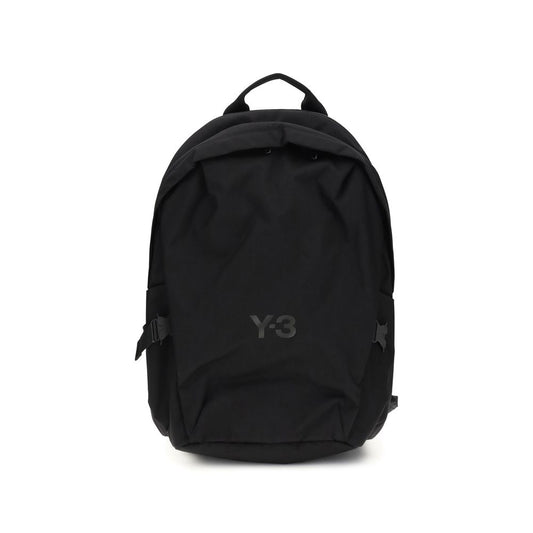 Large Backpack by Y-3 for men in cordura metal nylon & polyamide black showcases an architectural Cordura Metal Nylon & Polyamide Large Backpack design, featuring a secure buckle, ample built-in-compartments, external-pockets & laptop-compartment, and architectural backpack-strap for a sophisticated look.