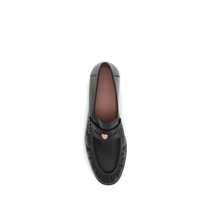 Flat Loafer Slip-On Strap Shoes by Chloé for women in bos taurus calf leather black & signature showcases a timeless silhouette from the Women's Bos Taurus Calf Leather Flat Loafer Slip-On Strap Shoes collection, featuring a timeless flat and for a timeless finish.