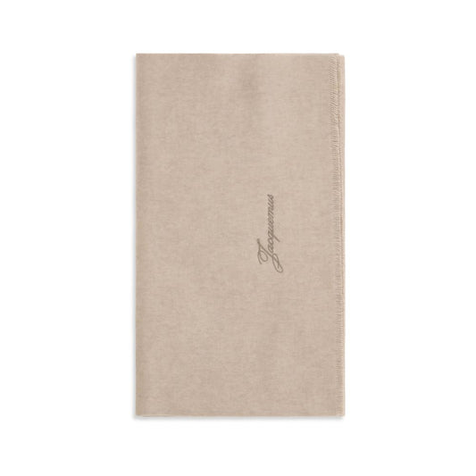 Scarf by Jacquemus for men in merino wool beige showcases a warm silhouette from the Merino Wool Fringes Scarf collection, offering a warm drape that exudes sophisticated luxury.