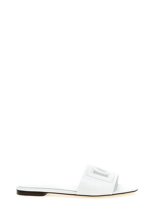 Sliders Flat Shoes by Dolce & Gabbana for women in calfskin leather white showcases a dynamic silhouette, artfully capturing Women's Calfskin Leather Sliders Flat Shoes through its distinctive and elegant .