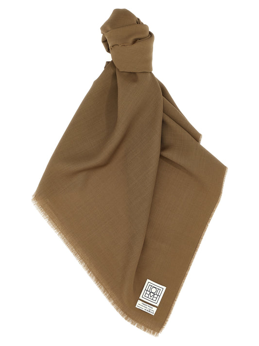 Scarf by TOTEME for women in virgin wool brown showcases a eye catching silhouette, artfully capturing the essence of the eye catching Virgin Wool Foulard Wrap Fringes Scarf design for a sophisticated look.