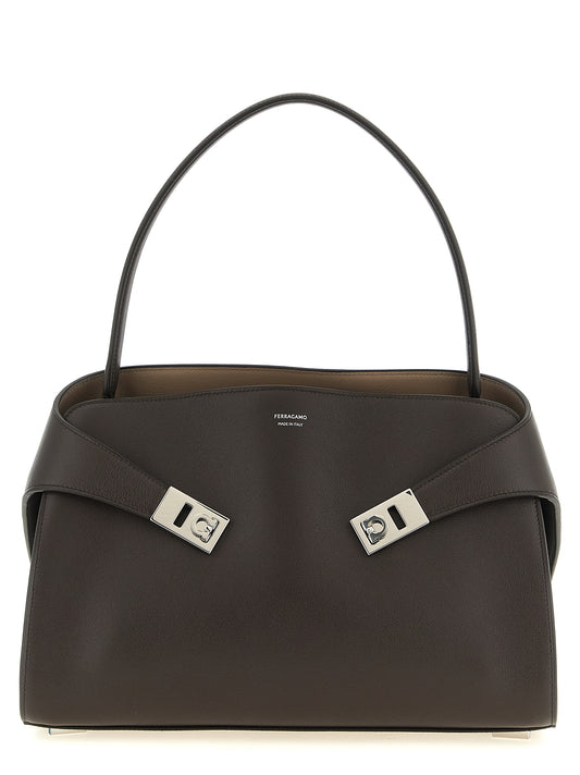 Shoulder Bag by Ferragamo for women in bos taurus calfskin leather brown & silver features a effortless chic silhouette with a secure , ample , and versatile shoulder-strap, handle & adjustable-strap for a effortless chic finish.
