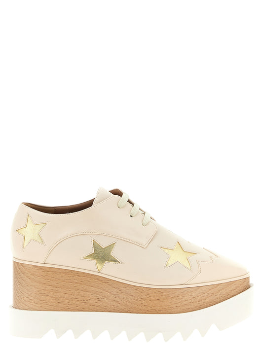 Platform Wedge Lace-Up Sandals by Stella McCartney for women in polyester faux leather gold, ivory & white showcases a sculptural silhouette as Star Women's Polyester Faux Leather Platform Wedge Lace-Up Sandals, defined by a sculptural platform wedge and sculptural for a sculptural look.