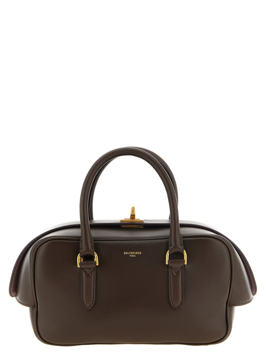 This Shoulder Bowling Handbag by Balenciaga for women in nappa lamb leather and brown, gold & pink presents a sculptural silhouette featuring a secure , ample , and versatile shoulder-strap & adjustable-strap for a sculptural finish.