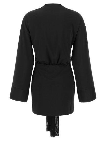 Dress by The Andamane for women in stretch polyester black presents a sinuous silhouette, showcasing a sophisticated v-neck neckline and detailed with a sinuous short mini for a refined finish.