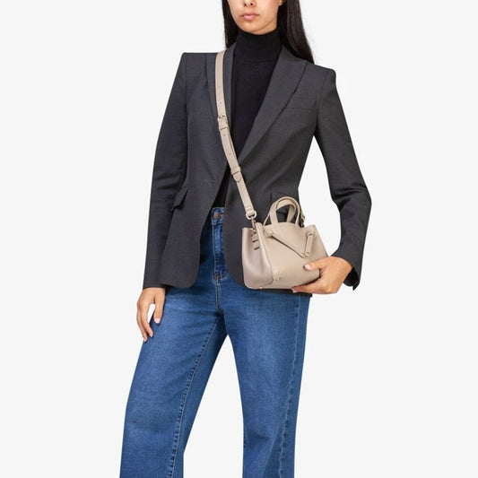 This Handbag by MIRIADE for women in polyethylene & polyurethane and beige presents a sculptural silhouette featuring a secure , ample , and versatile for a sculptural finish.