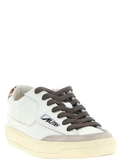 Sneakers by Autry for women in cowhide suede leather animal, cream, gray, multicolor, white & print presents a on trend silhouette from the Pony Women's Low Top Cowhide Suede Leather Sneakers collection, showcasing a on trend low-top style for an elevated aesthetic.