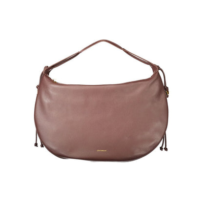 This Handbag by Coccinelle for women in leather and brown presents a sculptural silhouette featuring a secure zipper, ample document-holder & internal-pockets, and versatile handle for a sculptural finish.